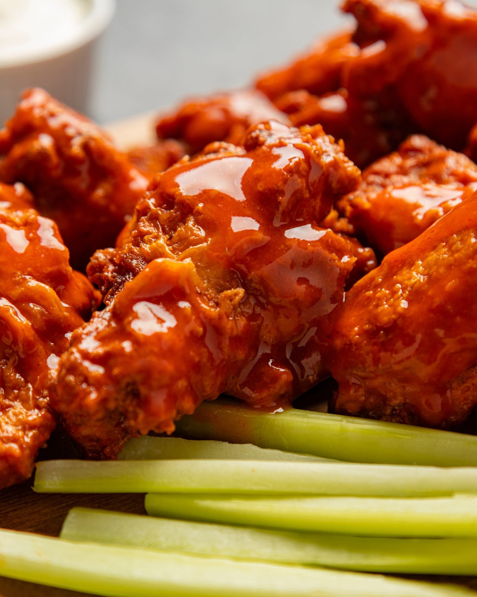 Buffalo wings glazed in sauce, served with celery