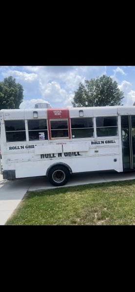 The Roll 'N' Grill truck parked on a sunny afternoon